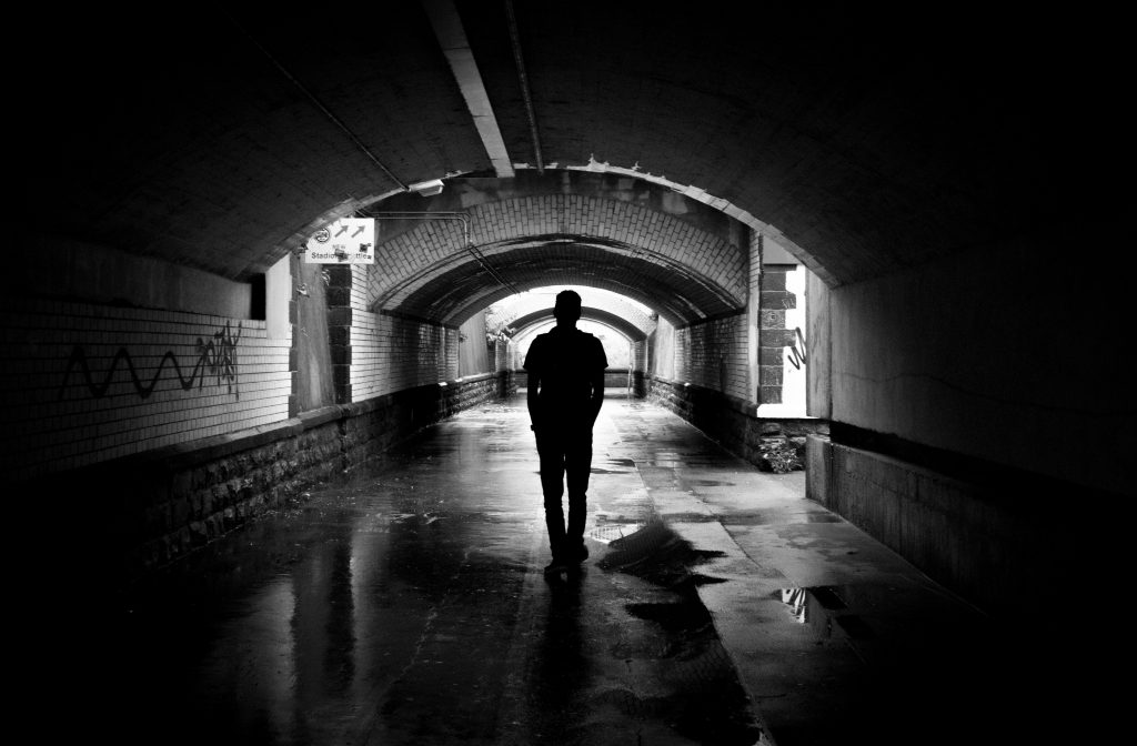 Dark silhouette on metro tunnel